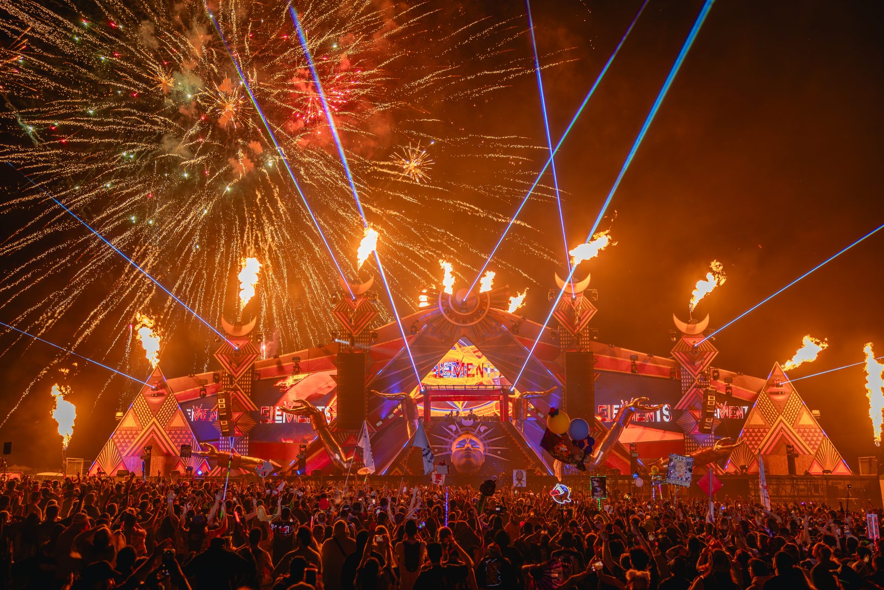 Festival main stage with flame effects, lasers and fireworks